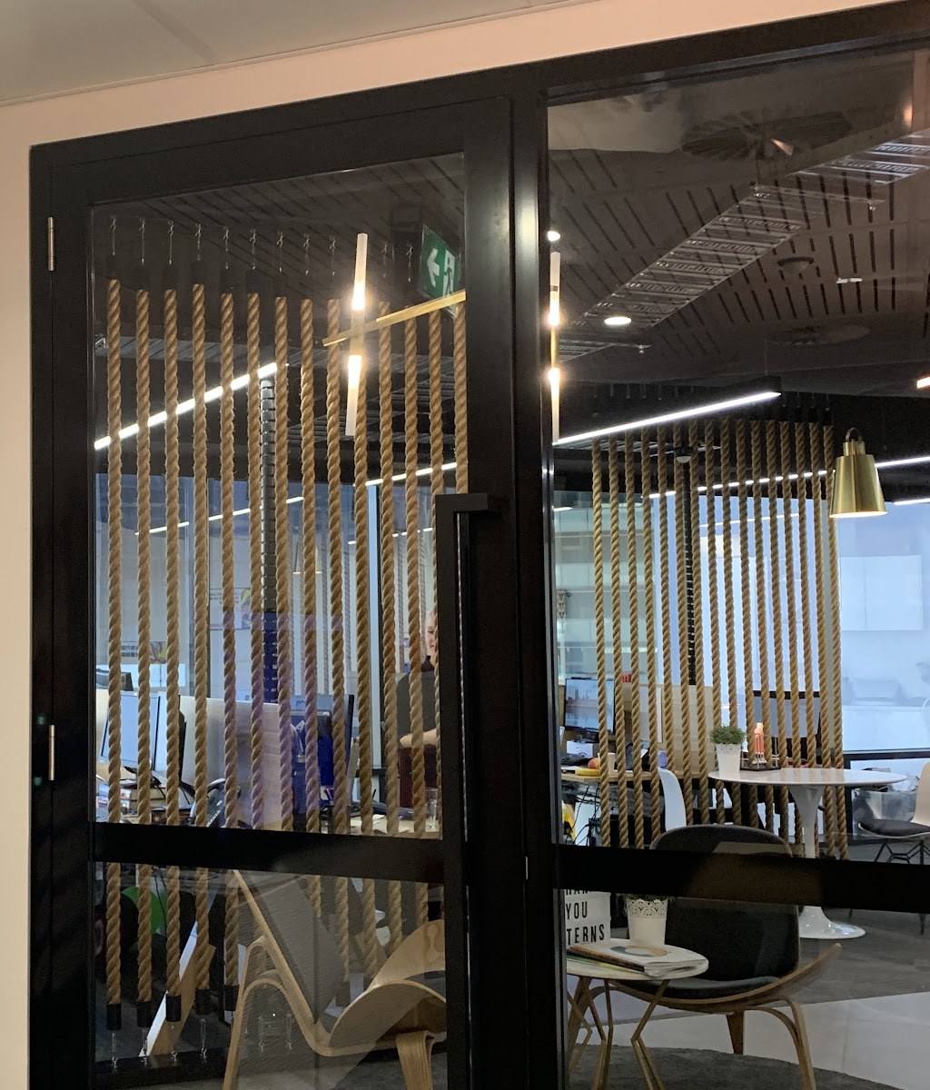 Black-framed glass doors into an office fit-out