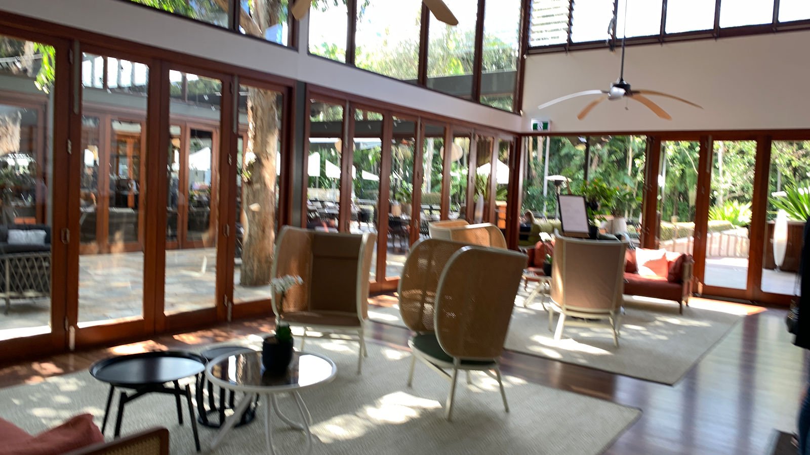 Timber-framed glass pavilion with a lounge inside